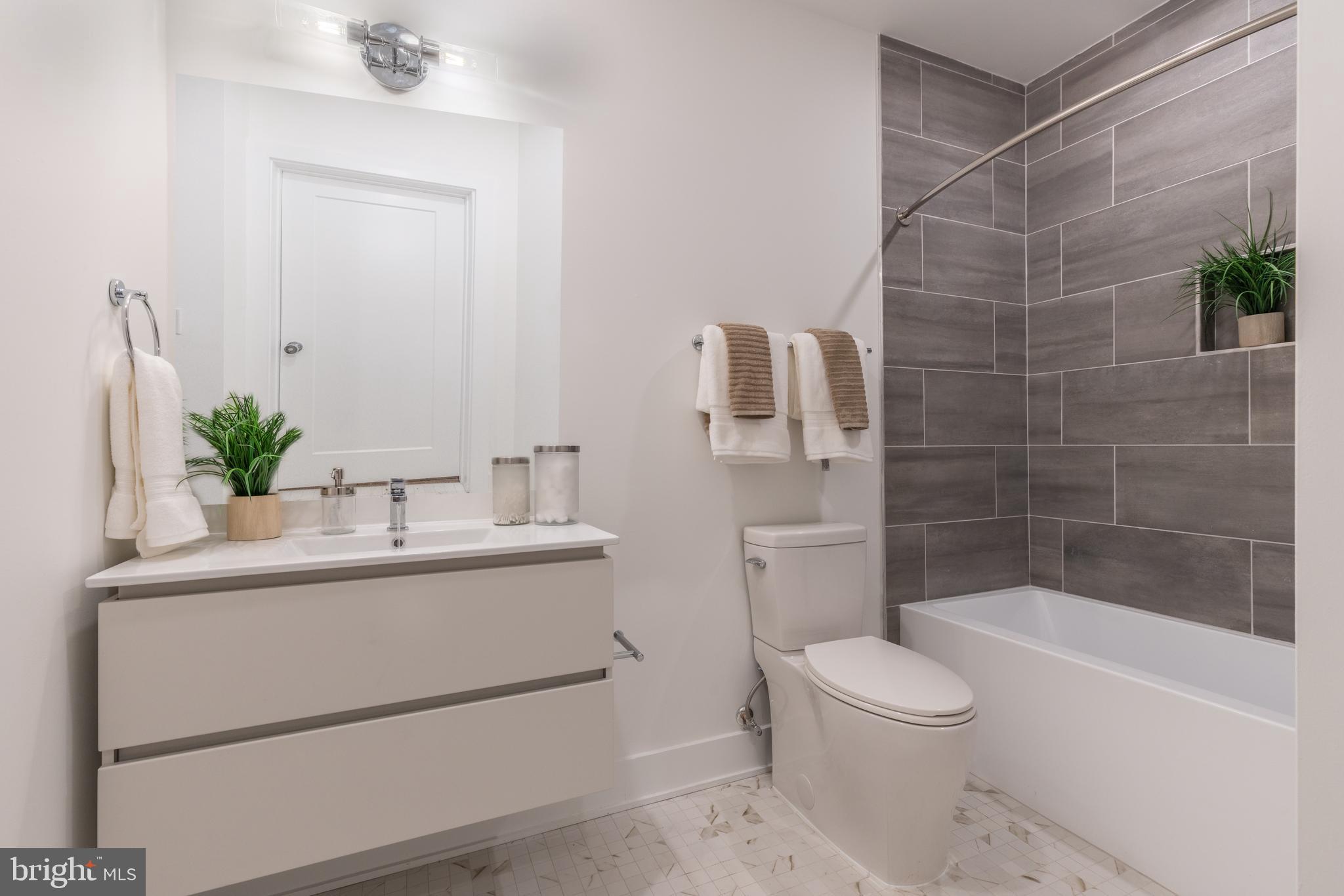 5545 Pulaski Avenue, Unit 401 Philadelphia, PA 19144 - Photo 16 of 16 a bathroom with a sink toilet and shower
