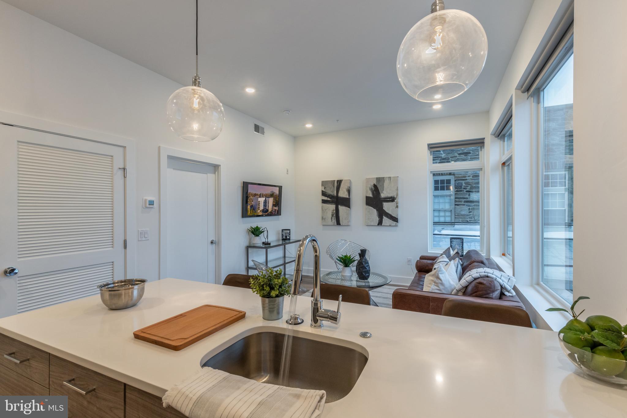 5545 Pulaski Avenue, Unit 401 Philadelphia, PA 19144 - Photo 2 of 16 a kitchen with sink refrigerator and window