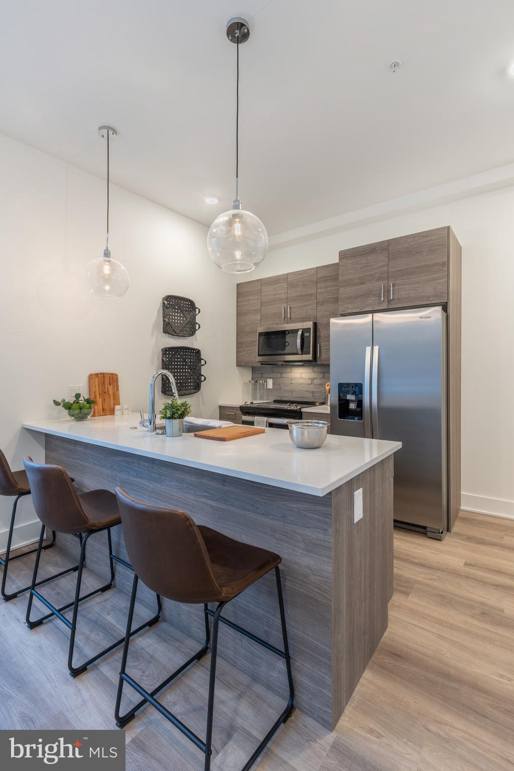 5545 Pulaski Avenue, Unit 401 Philadelphia, PA 19144 - Photo 7 of 16 a kitchen with stainless steel appliances granite countertop a sink a stove and a refrigerator