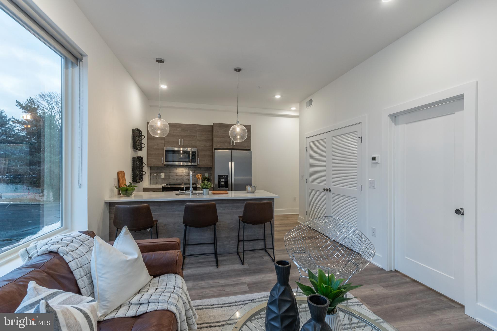 5545 Pulaski Avenue, Unit 401 Philadelphia, PA 19144 - Photo 8 of 16 a living room with furniture and a table