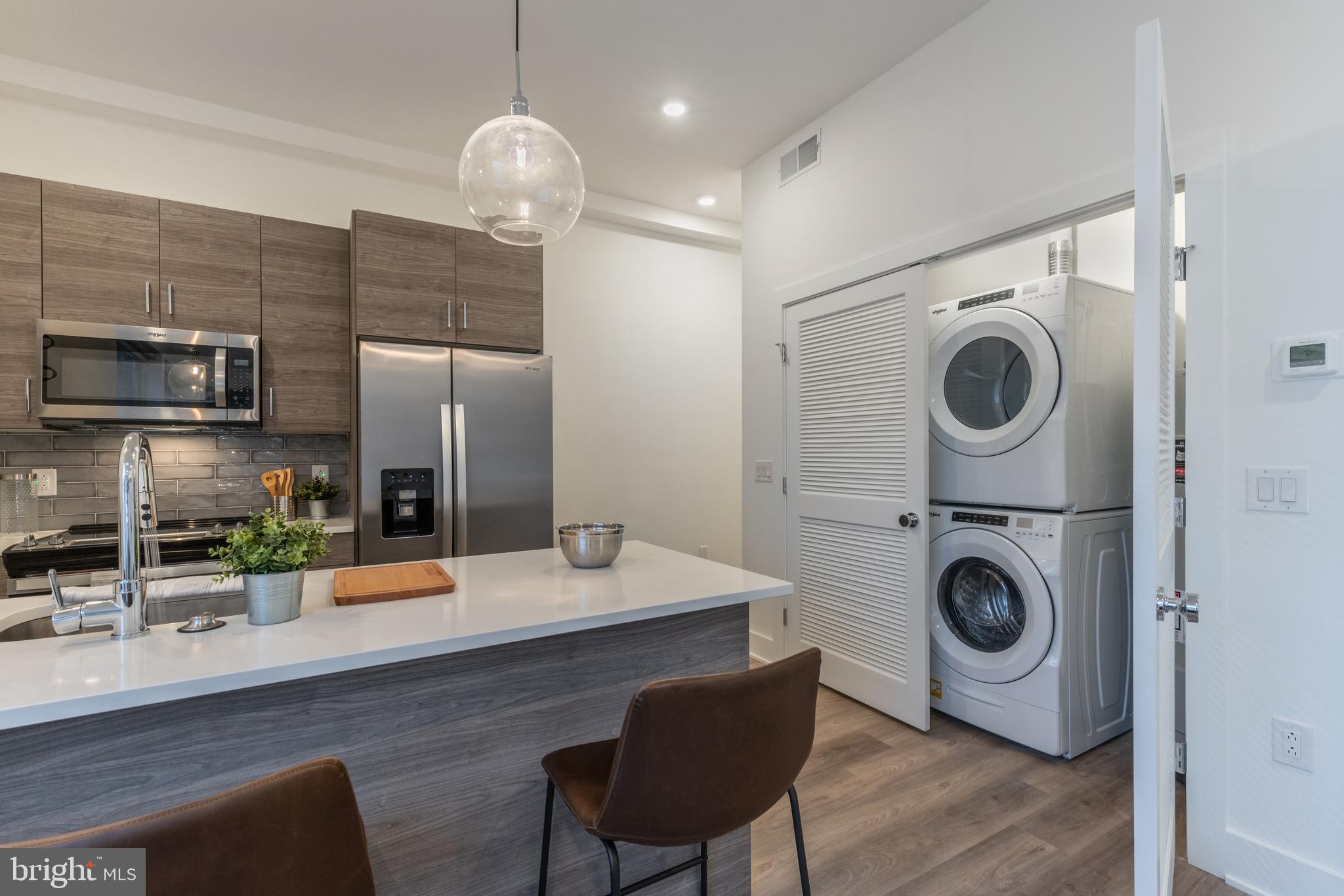 5545 Pulaski Avenue, Unit 401 Philadelphia, PA 19144 - Photo 10 of 16 a view of kitchen with a sink and a wooden floor