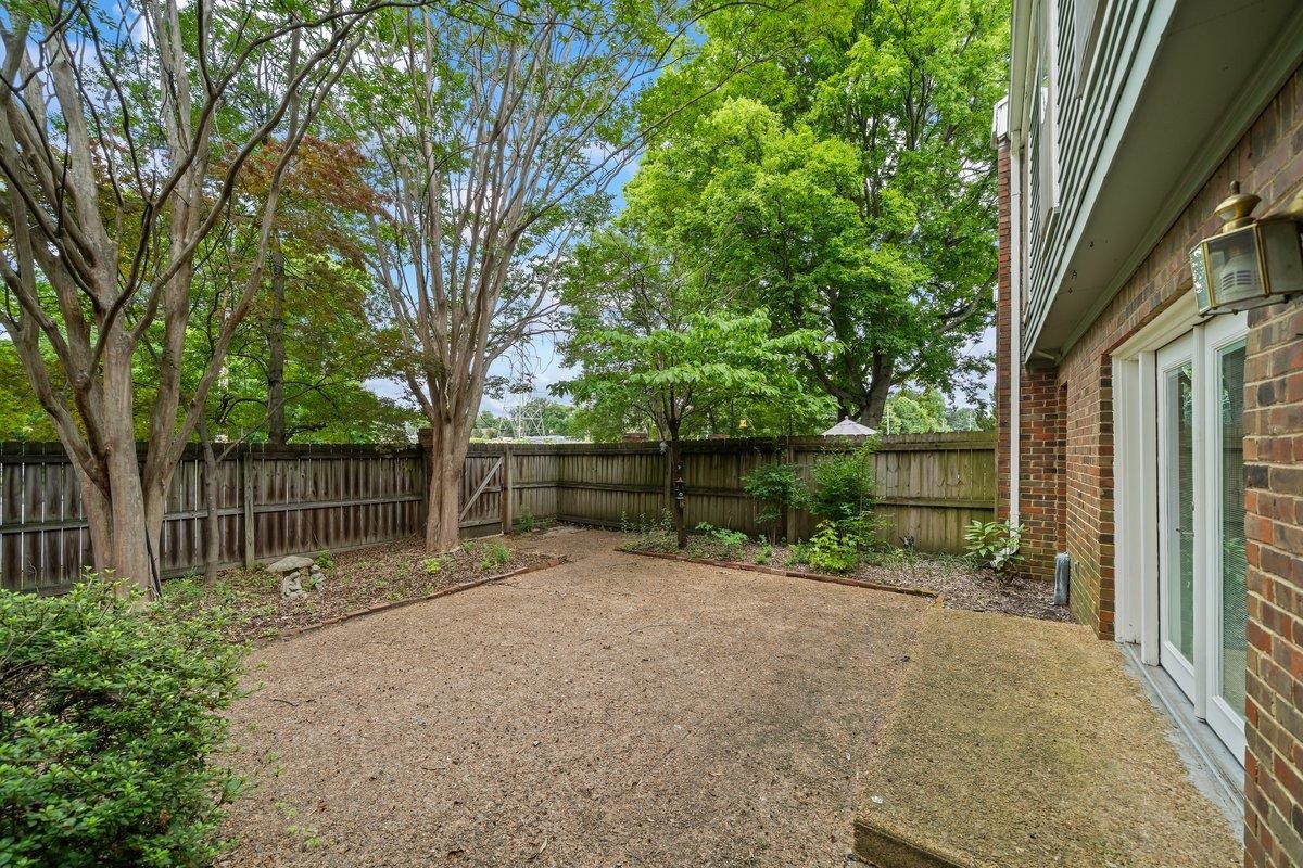 6942 Amberly Road, Unit 6942 Memphis, TN 38119 - Photo 20 of 23 a backyard of a house with lots of green space