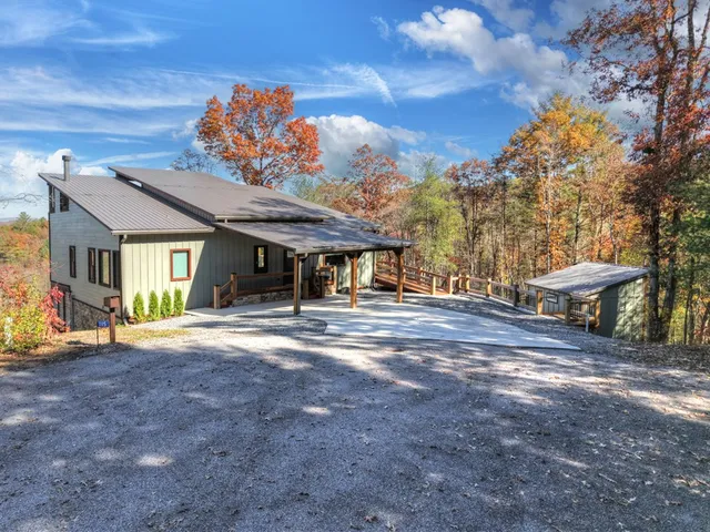 a view of a house with a yard and pathway