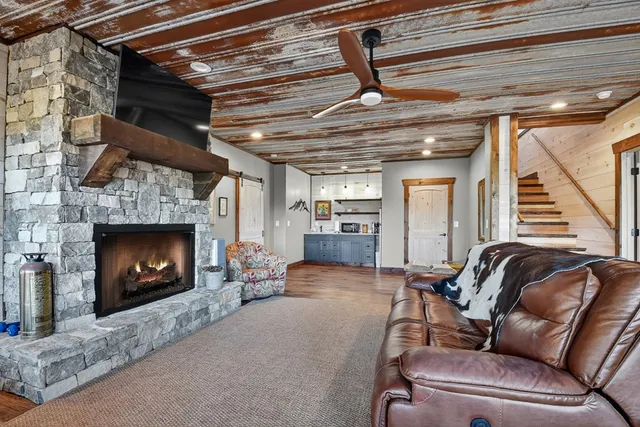 a living room with furniture a large window and a dining table