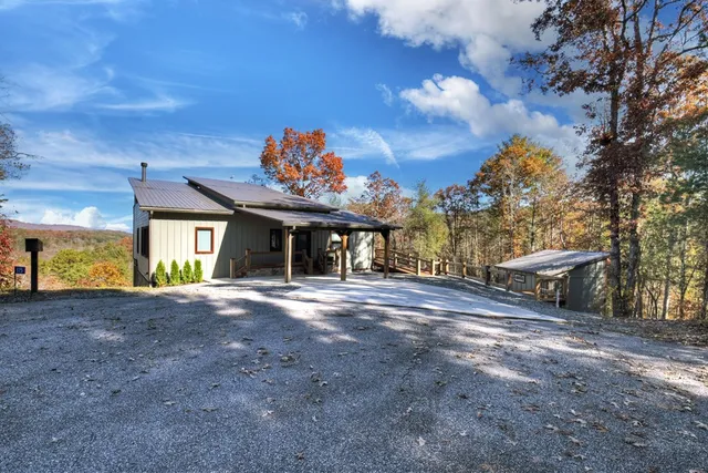 a kitchen with stainless steel appliances granite countertop a refrigerator a sink dishwasher a stove and a dining table with wooden floor