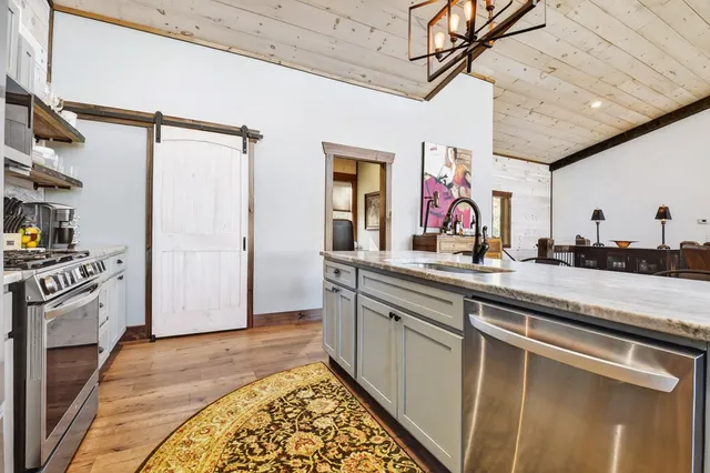 a living room with furniture a fireplace and a floor to ceiling window