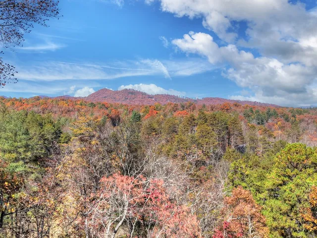 a view of mountain with sunset in background