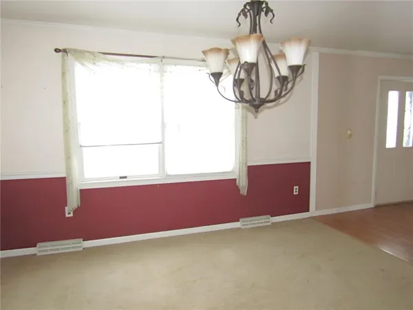 a room with window and a chandelier