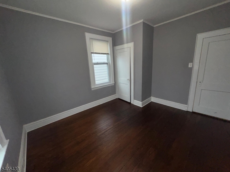 742 Pennington Street Elizabeth, NJ 07202 - Photo 11 of 11 an empty room with wooden floor and windows