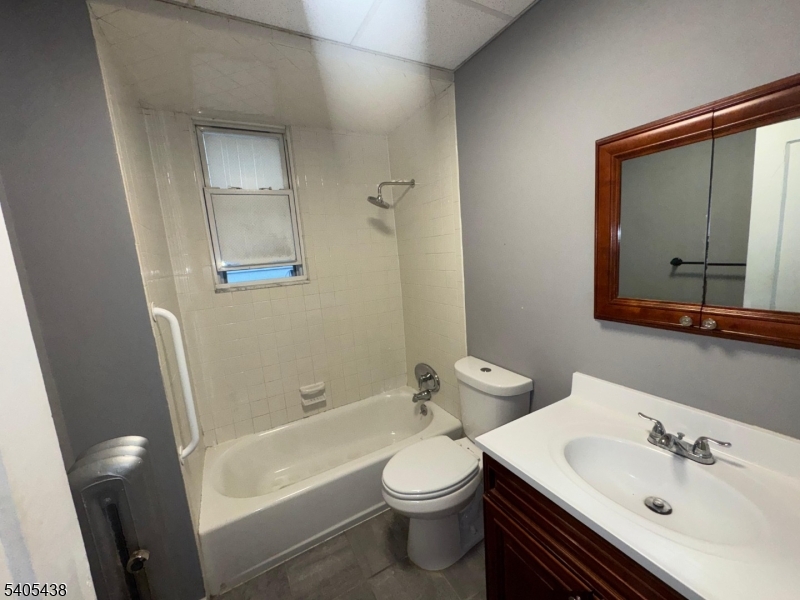 742 Pennington Street Elizabeth, NJ 07202 - Photo 3 of 11 a bathroom with a sink a toilet and shower