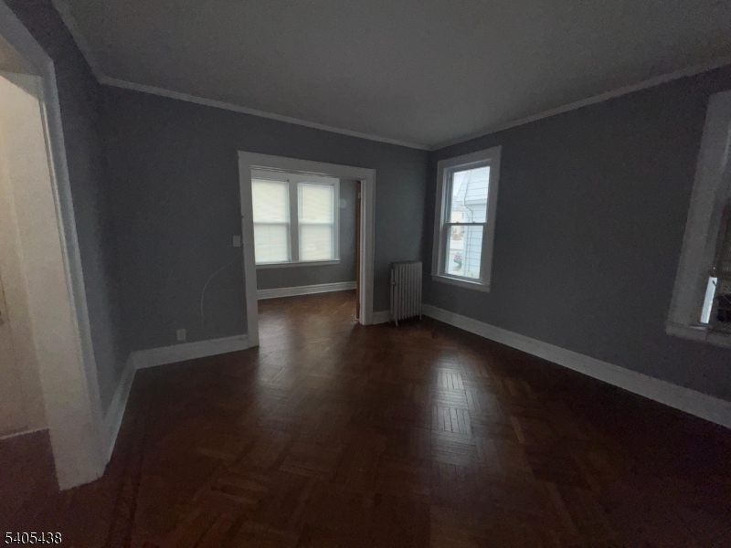 742 Pennington Street Elizabeth, NJ 07202 - Photo 8 of 11 an empty room with wooden floor and windows
