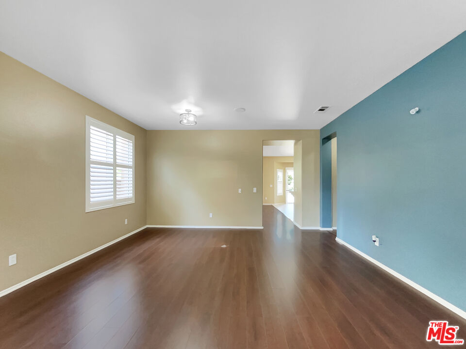 24025 Via Sereno Valencia, CA 91354 - Photo 11 of 27 a view of an empty room with wooden floor and a window