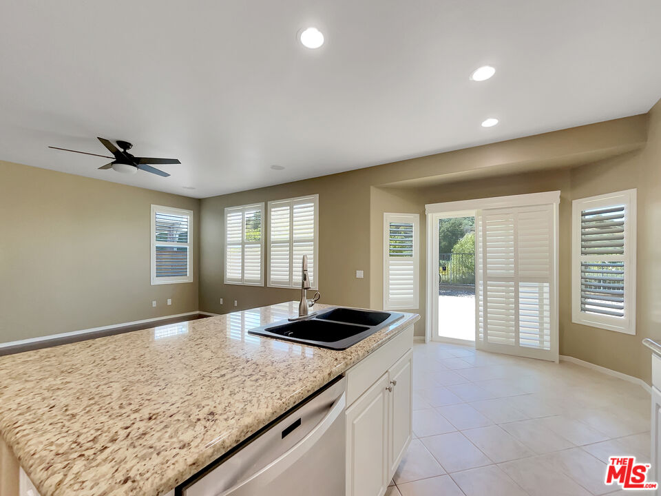 24025 Via Sereno Valencia, CA 91354 - Photo 17 of 27 a view of a kitchen island a sink and dishwasher