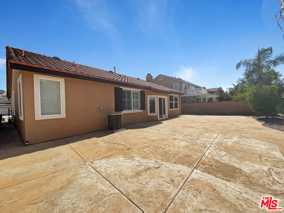 24025 Via Sereno Valencia, CA 91354 - Photo 8 of 27 a backyard of a house with large trees