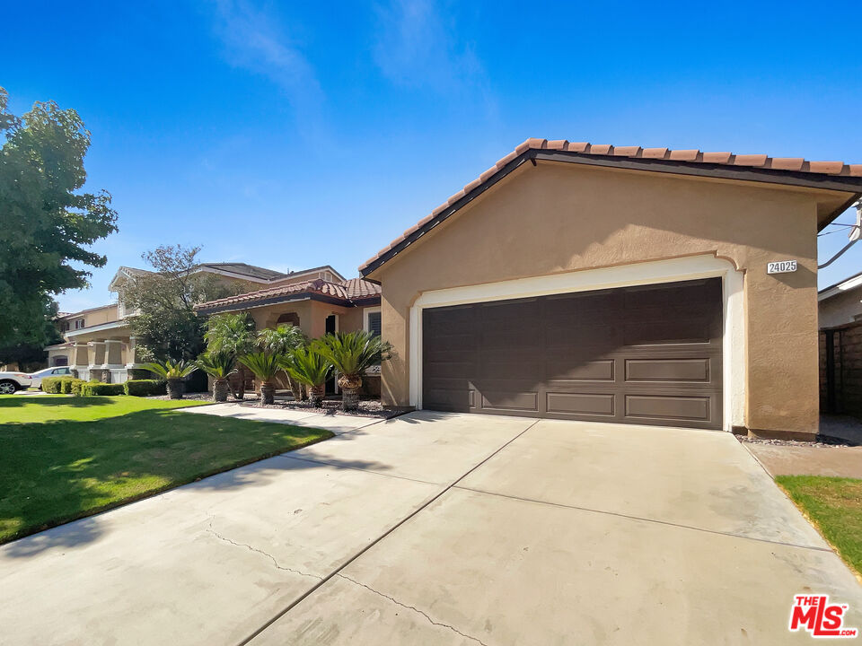 24025 Via Sereno Valencia, CA 91354 - Photo 10 of 27 a front view of a house with a yard and garage