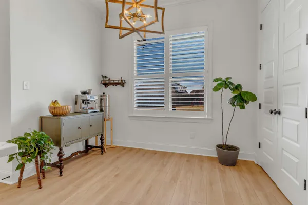 a view of a workspace with furniture and a potted plant