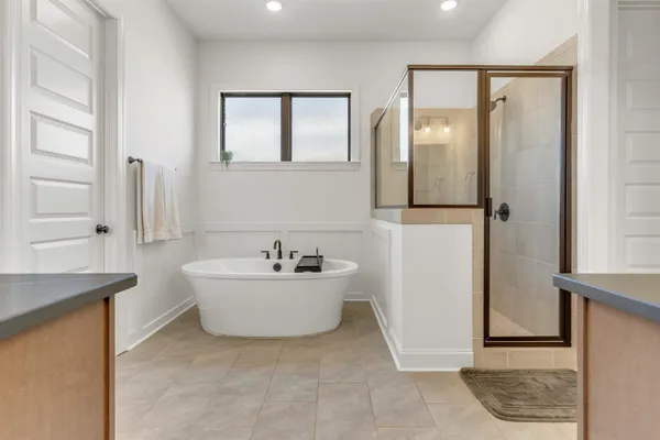 a bathroom with a bathtub sink and mirror