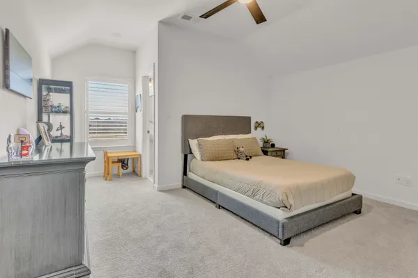 a bed room with a bed and window