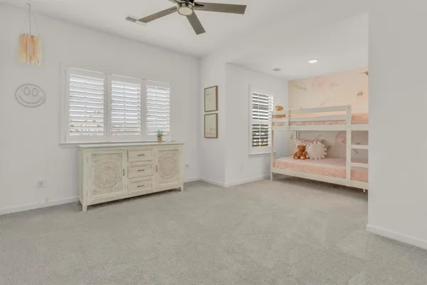a view of room with window and a ceiling fan