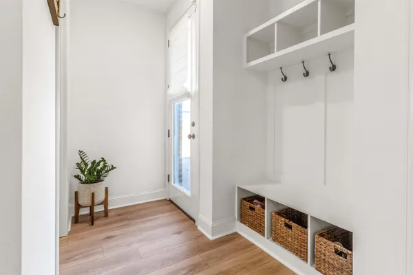 a view of an entryway with wooden floor