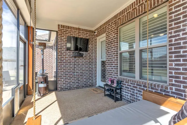 a view of a patio with a table and chairs