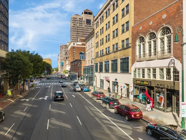 a city street lined with buildings and cars
