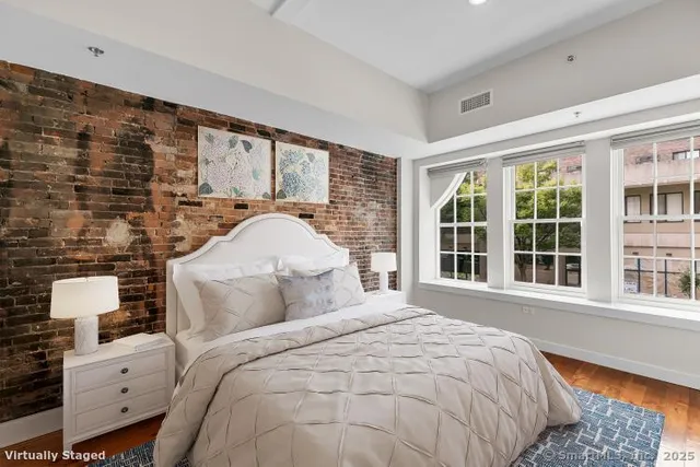 a bedroom with a bed and a window