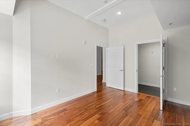 a view of a room with wooden floor