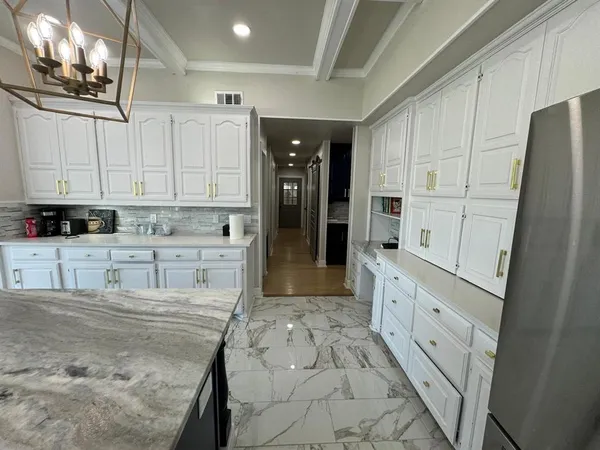 a kitchen with stainless steel appliances granite countertop a refrigerator sink and cabinets