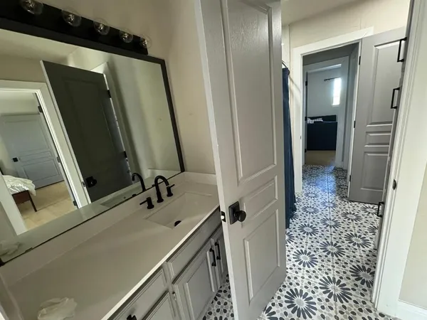 a bedroom with a bed and a mirror