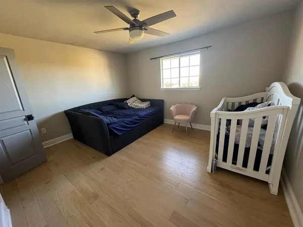 a bedroom with a bed and window