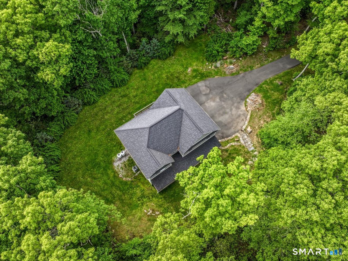 127 Putnam Park Road Bethel, CT 06801 - Photo 30 of 35 an aerial view of a house with a yard and trees all around