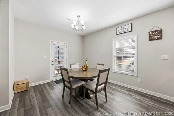 a view of a dining room with furniture and wooden floor