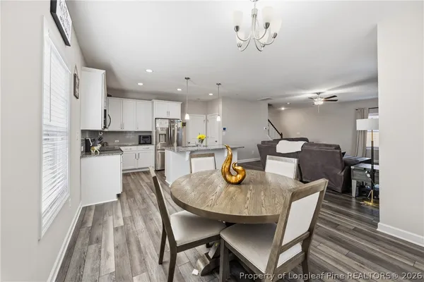 a kitchen with a dining table chairs and kitchen view