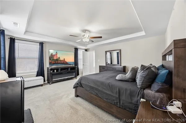 a bedroom with furniture and a flat screen tv