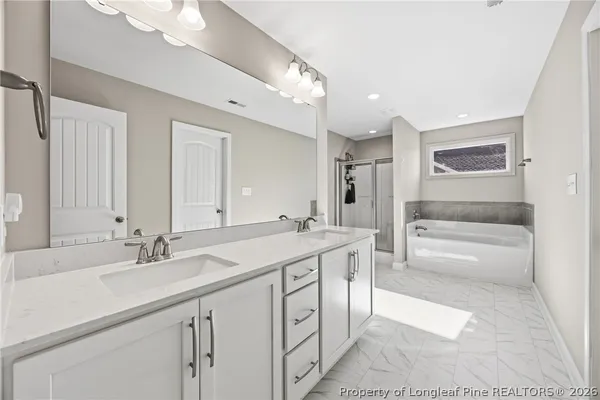 a spacious bathroom with a granite countertop sink a toilet a mirror and shower