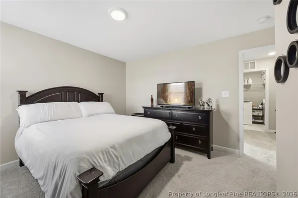 a bedroom with a bed and a television