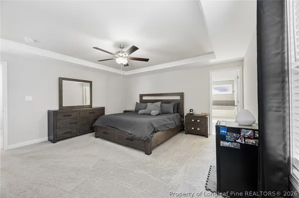 a spacious bedroom with a bed and a ceiling fan