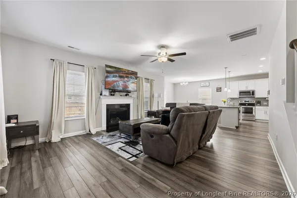 a living room with furniture fireplace and flat screen tv