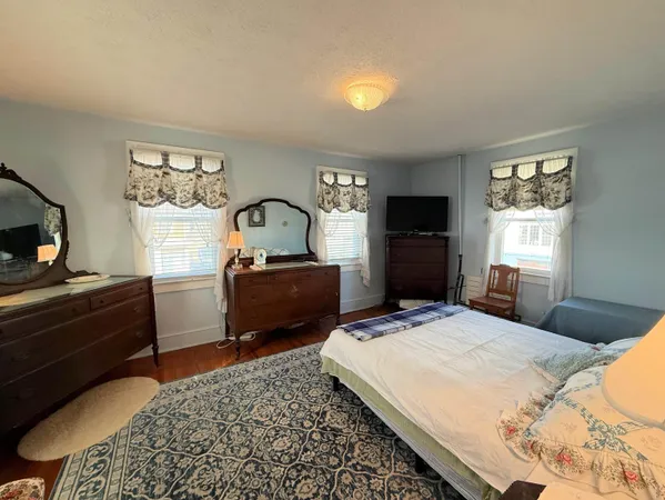 a bedroom with a bed and a television