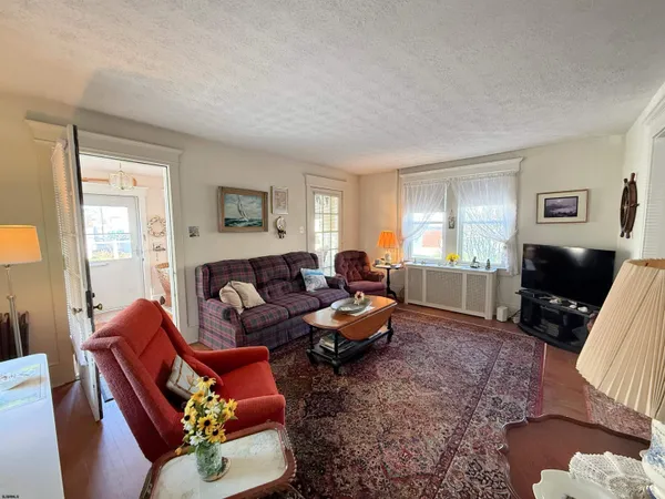 a living room with furniture a window and a flat screen tv