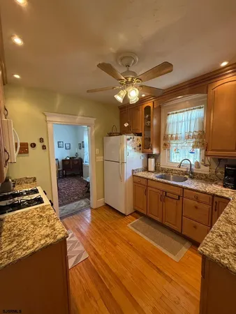 a kitchen with a sink appliances cabinets and a counter top space