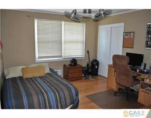 64 Ridge Road Edison, NJ 08817 - Photo 12 of 22 a bedroom with a bed a desk and chair