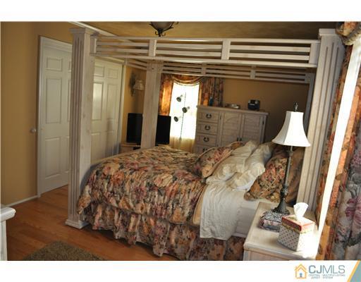 64 Ridge Road Edison, NJ 08817 - Photo 14 of 22 a bed sitting in a bedroom next to a window