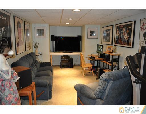 64 Ridge Road Edison, NJ 08817 - Photo 15 of 22 a living room with furniture and a flat screen tv