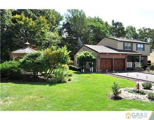 64 Ridge Road Edison, NJ 08817 - Photo 3 of 22 a front view of a house with garden