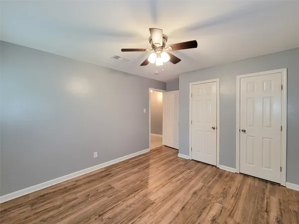 a view of an empty room and wooden floor