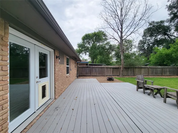 a view of backyard with outdoor seating ad green space