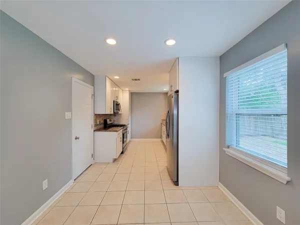 a view of a kitchen with a sink and a refrigerator