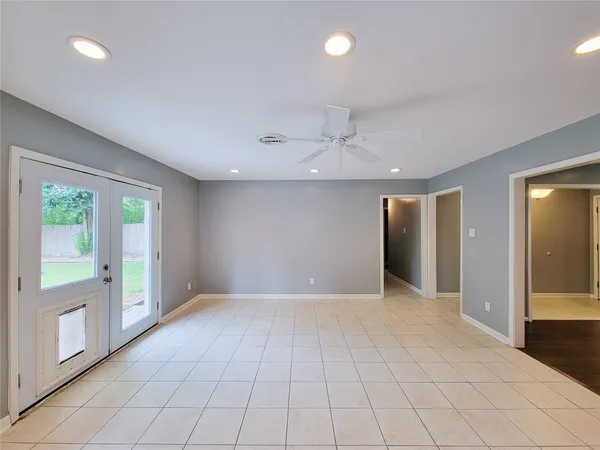 an empty room with windows and entrance